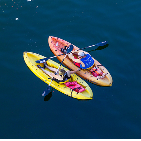 two people laying on two paddleboards